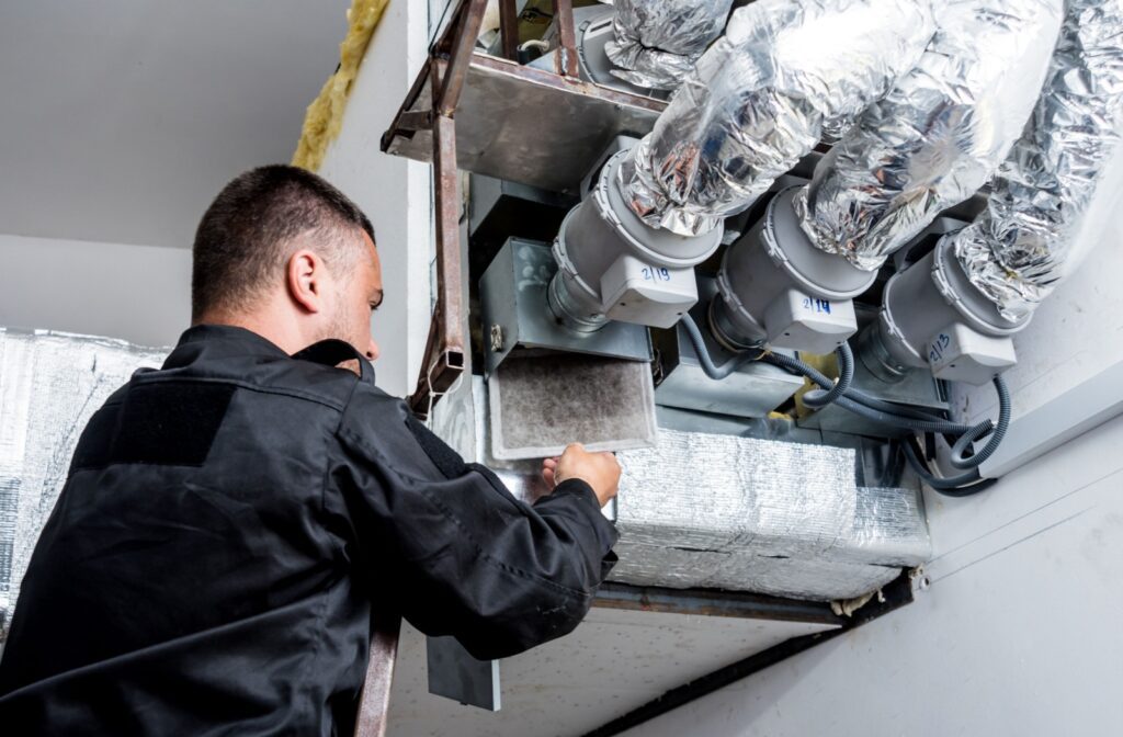 A person assesses the home's air filtration system before cleaning the air ducts.
